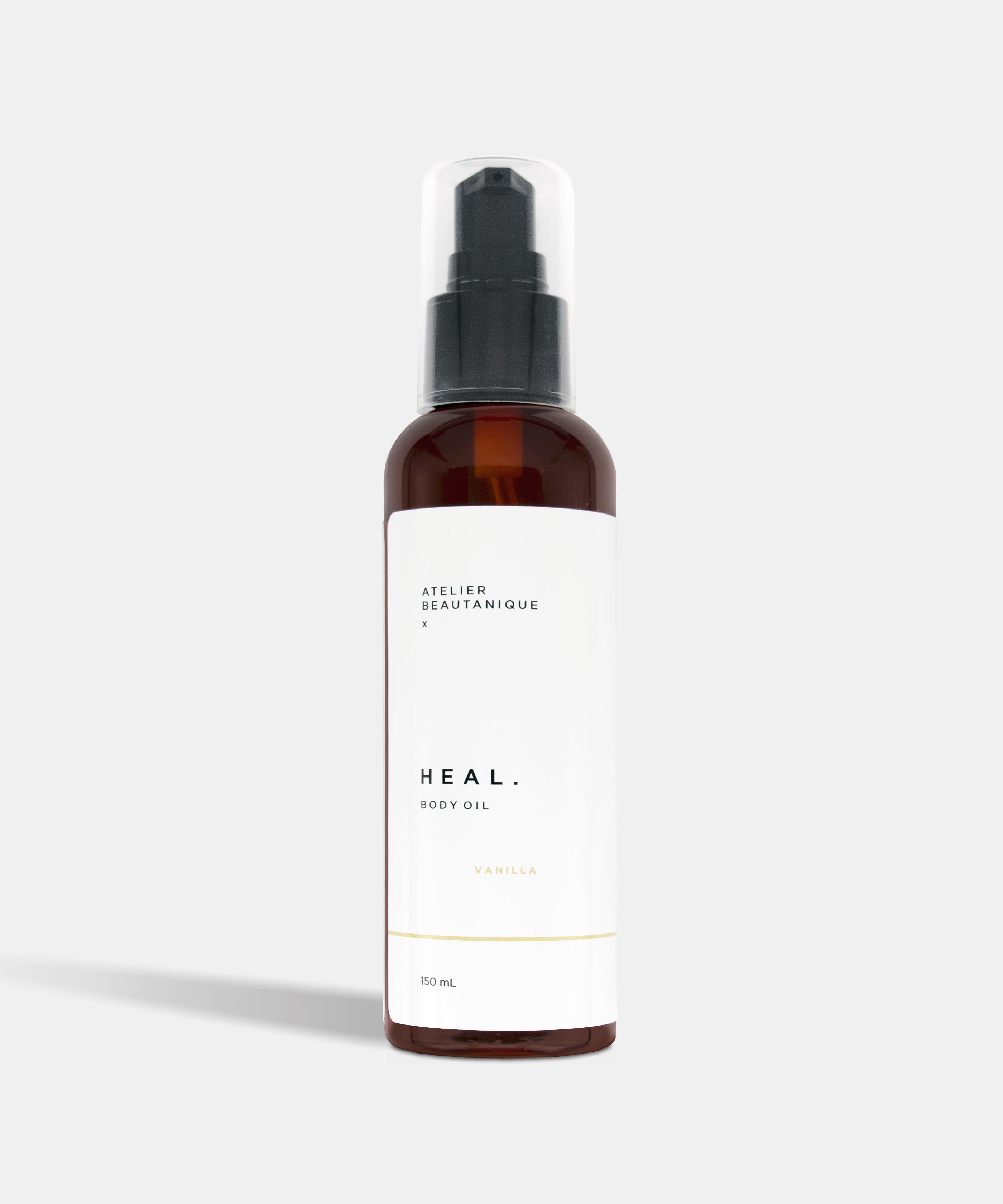 Atelier Beautanique HEAL. Vanilla Body Oil Bottle on Grey Background with Light Shadow