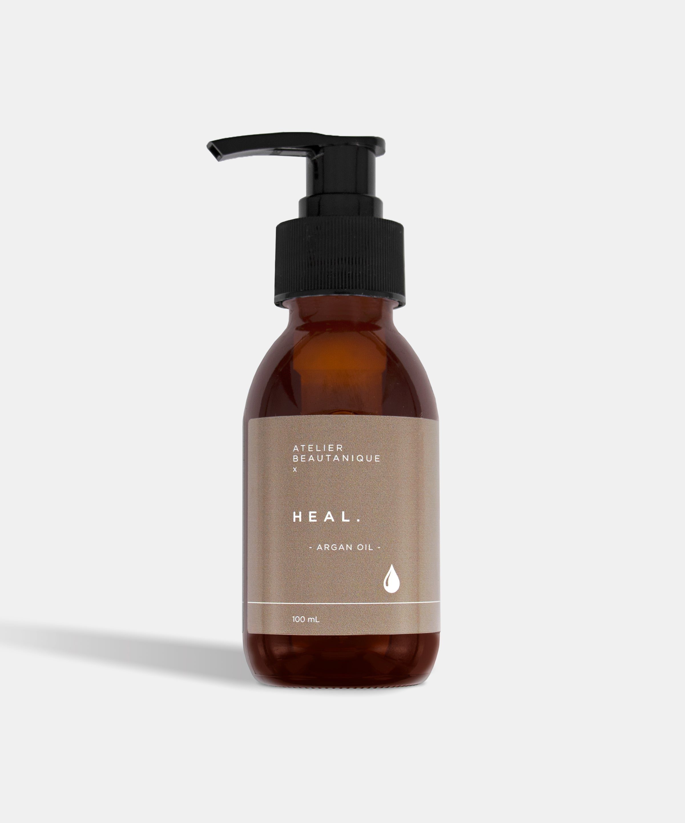 Atelier Beautanique HEAL. Argan Oil Bottle on Grey Background with Light Shadow