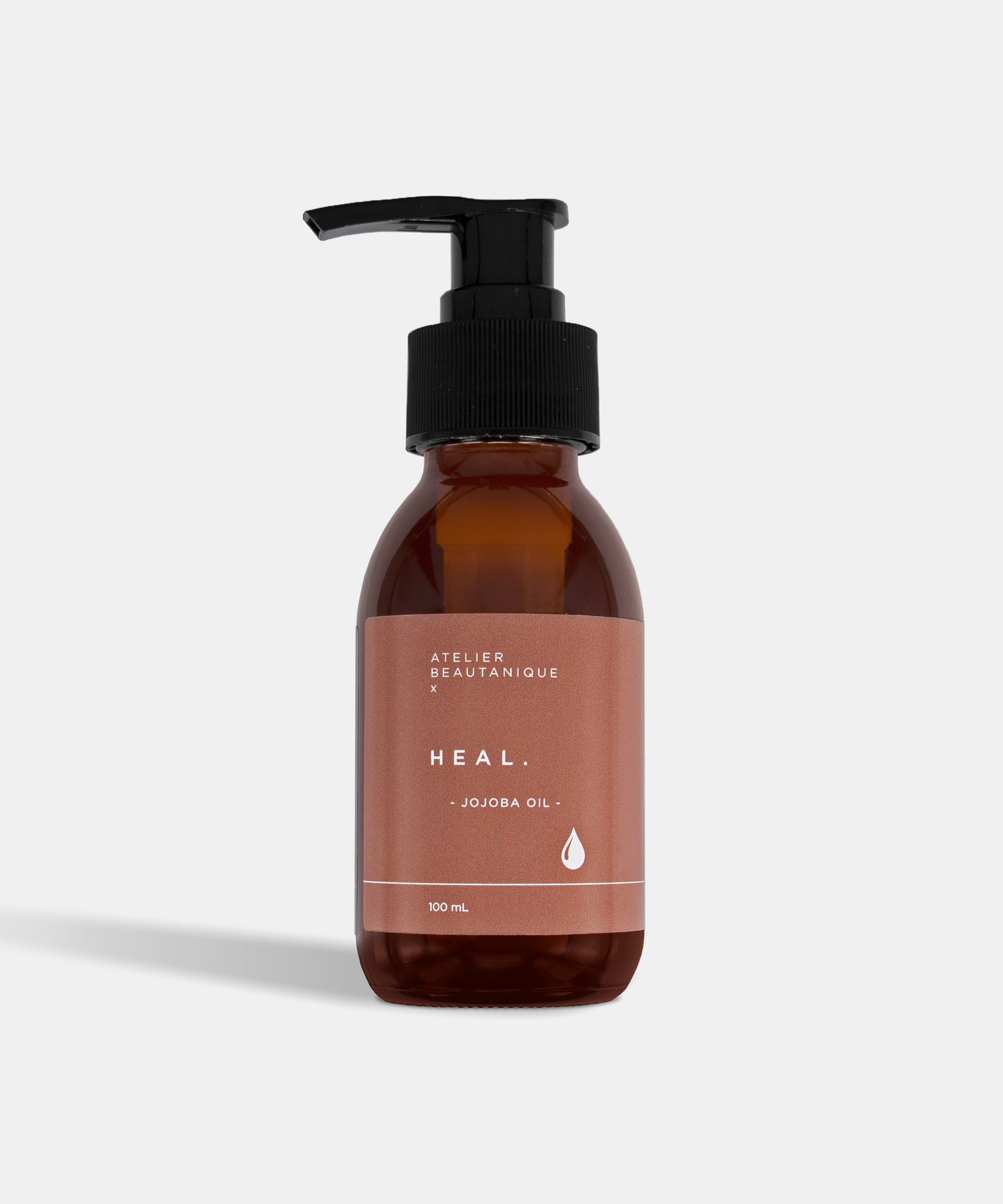Atelier Beautanique HEAL. Jojoba Oil Bottle on Grey Background with Light Shadow