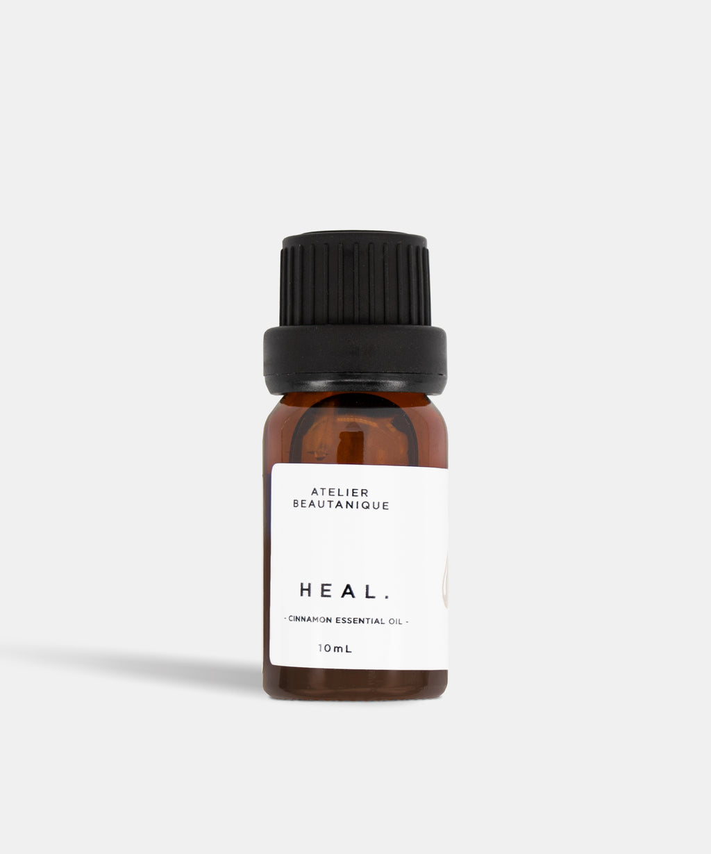 Atelier Beautanique HEAL. Cinnamon Essential Oil 10mL Bottle on Grey Background with Light Shadow