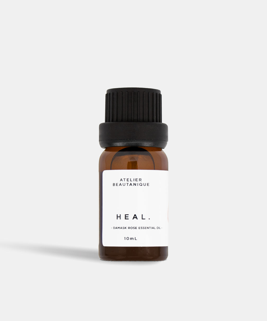 Atelier Beautanique HEAL. Rose Essential Oil 10mL Bottle on Grey Background with Light Shadow