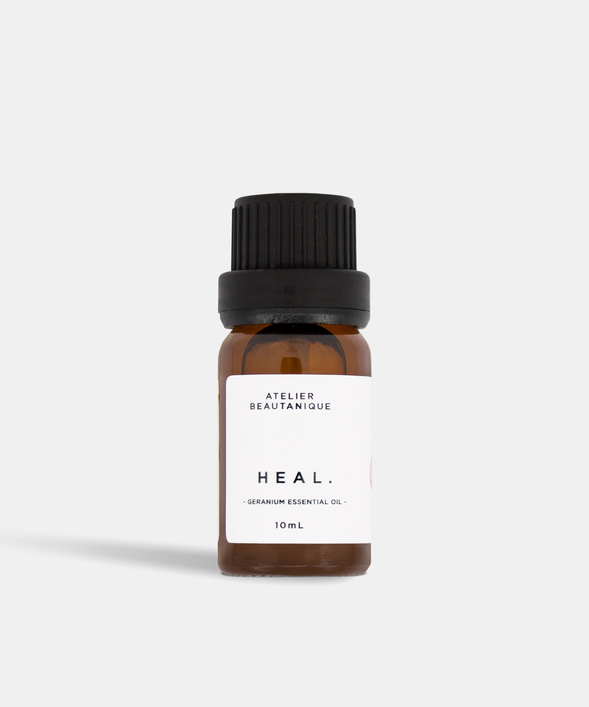 Atelier Beautanique HEAL. Geranium Essential Oil 10mL Bottle on Grey Background with Light Shadow