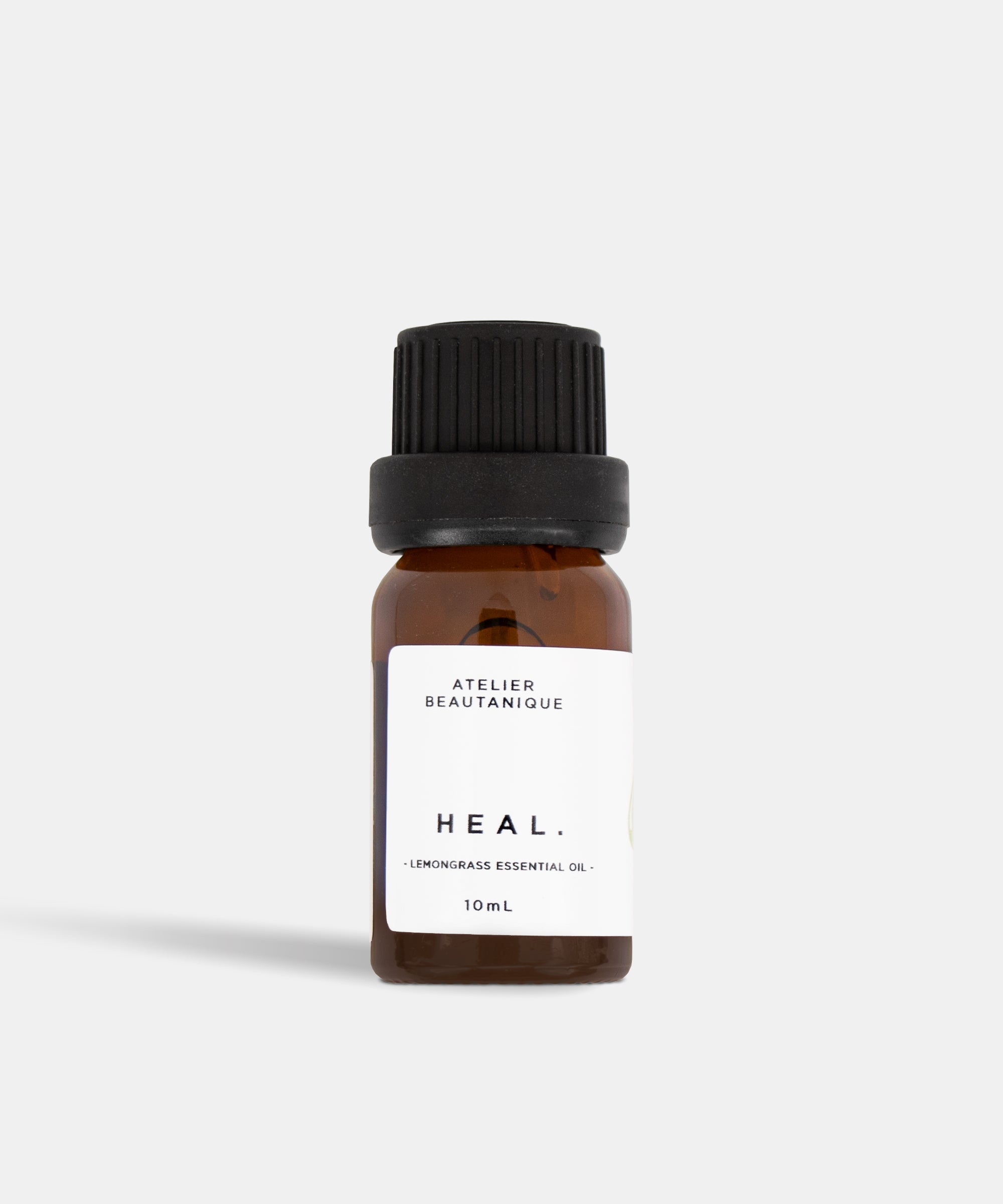 Atelier Beautanique HEAL. Lemongrass Essential Oil 10mL Bottle on Grey Background with Light Shadow