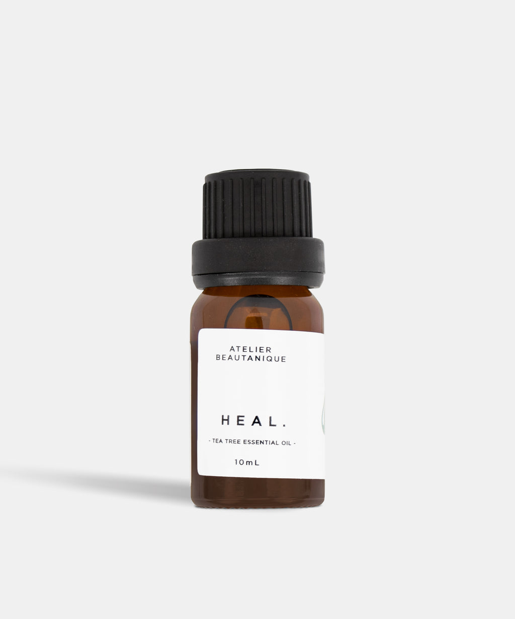 Atelier Beautanique HEAL. Tea Tree Essential Oil Bottle on Grey Background with Light Shadow