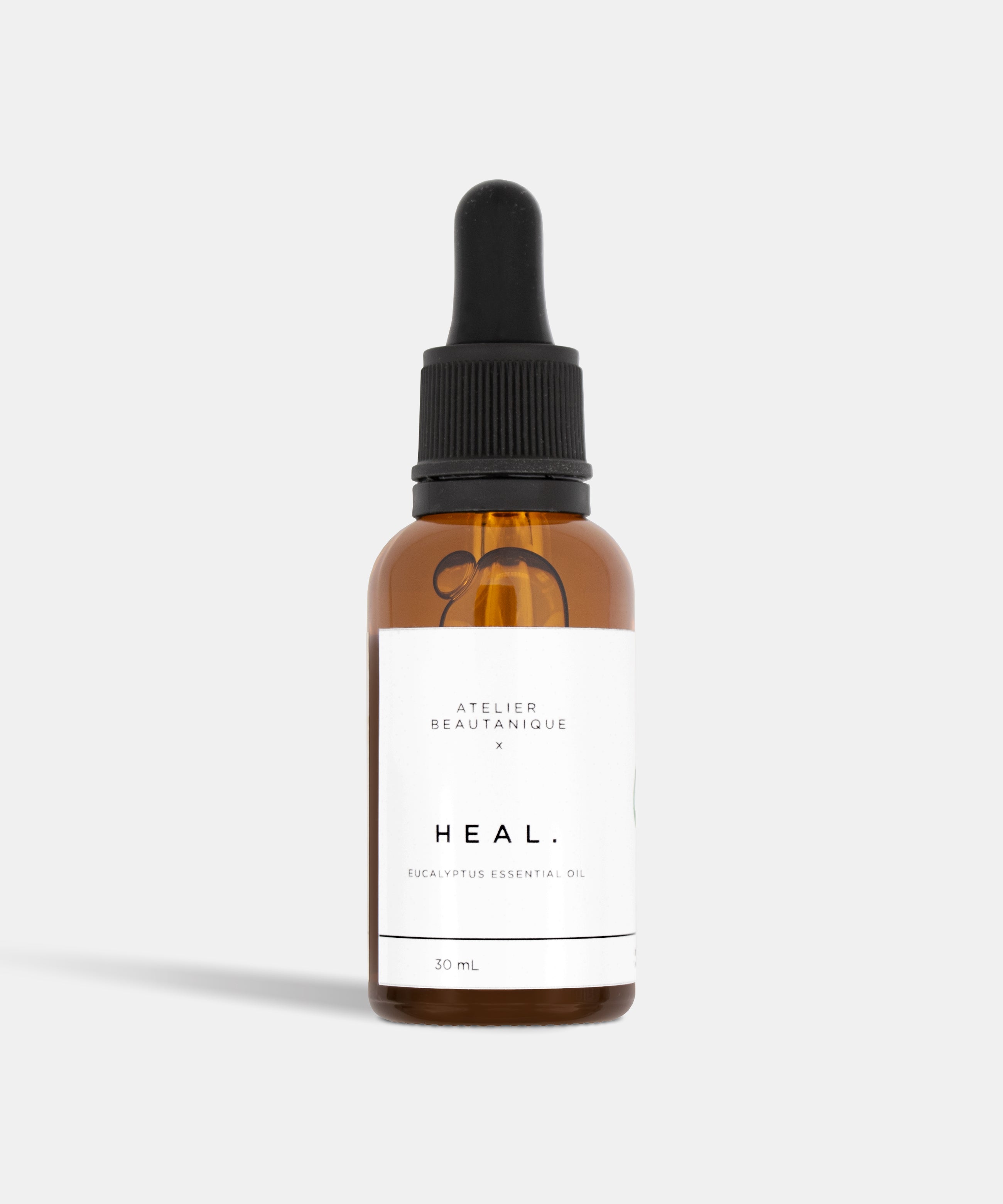 Atelier Beautanique HEAL. Eucalyptus Essential Oil 10mL Bottle on Grey Background with Light Shadow