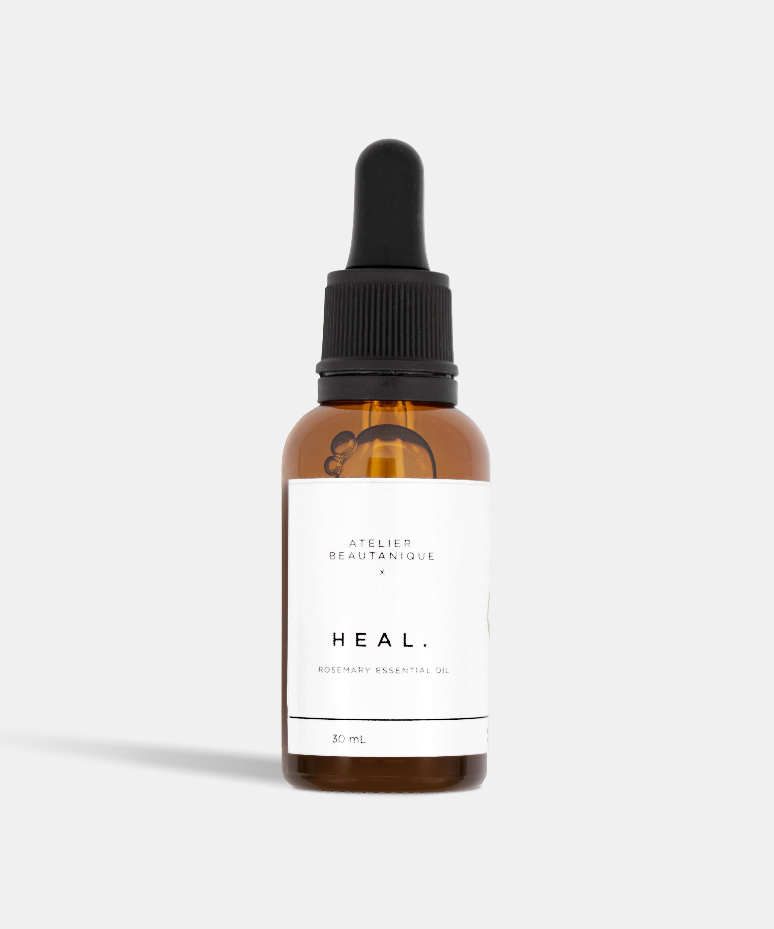 Atelier Beautanique HEAL. Rosemary Essential Oil 30mL Bottle on Grey Background with Light Shadow