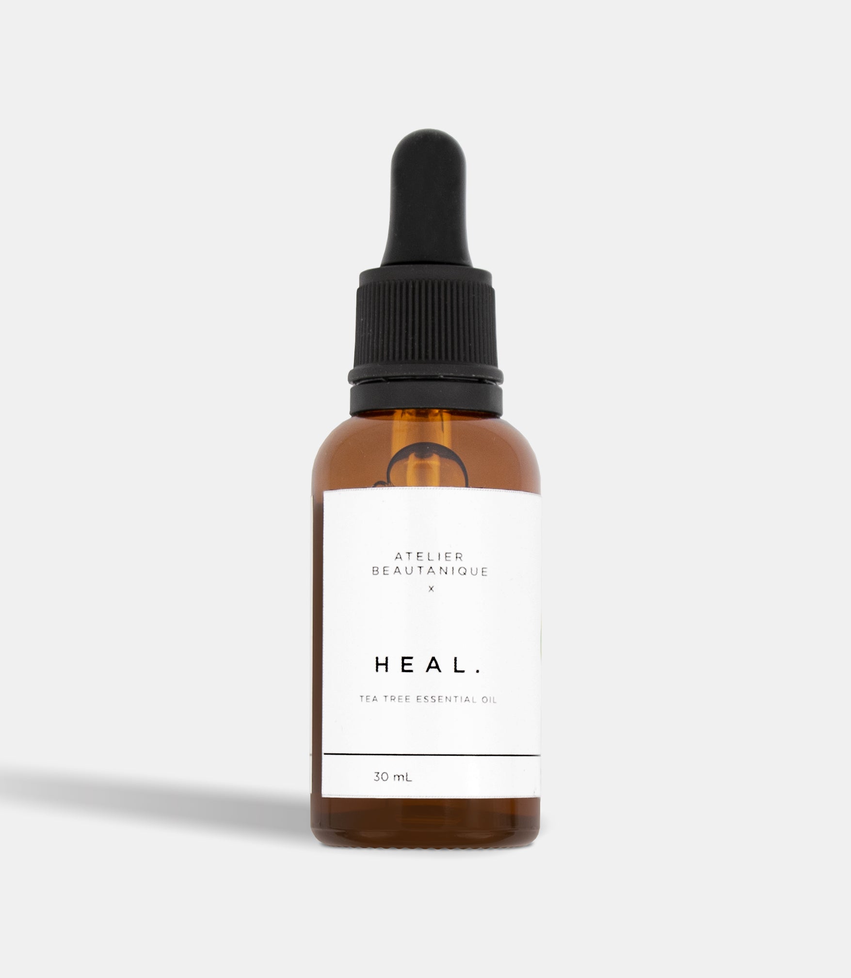 Atelier Beautanique HEAL. Tea Tree Essential Oil 30mL Bottle on Grey Background with Light Shadow