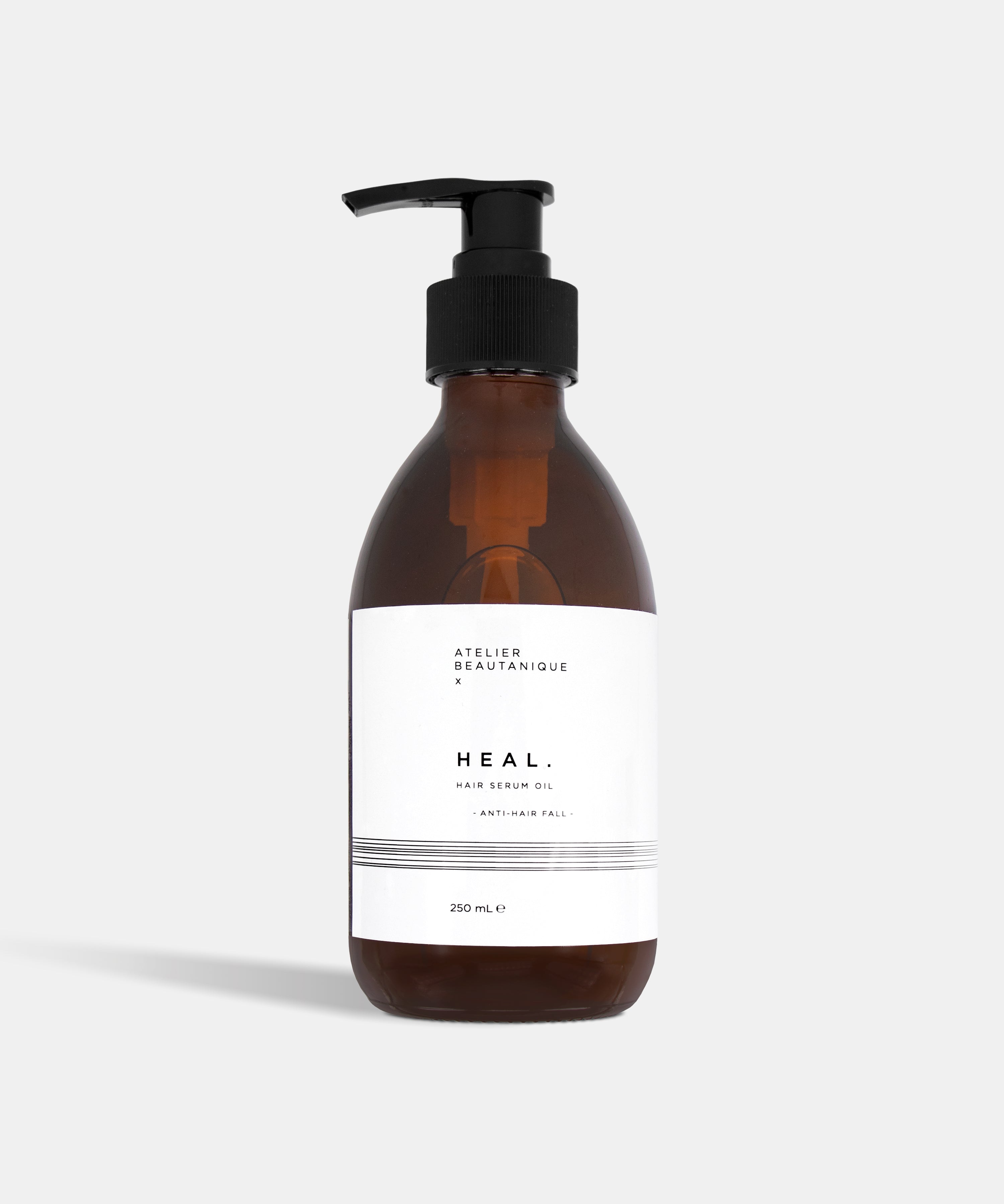 Atelier Beautanique HEAL. Anti-Hair Fall Hair Serum Oil Bottle on Grey Background with Light Shadow