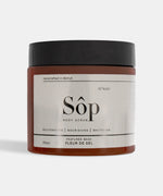 Load image into Gallery viewer, Atelier Beautanique Sôp Black Musk Body Scrub Jar on Gray Background with Light Shadow
