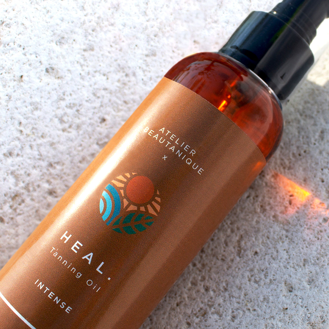 Atelier Beautanique HEAL. Tanning Oil Bottle on Grey Background with Light Shadow
