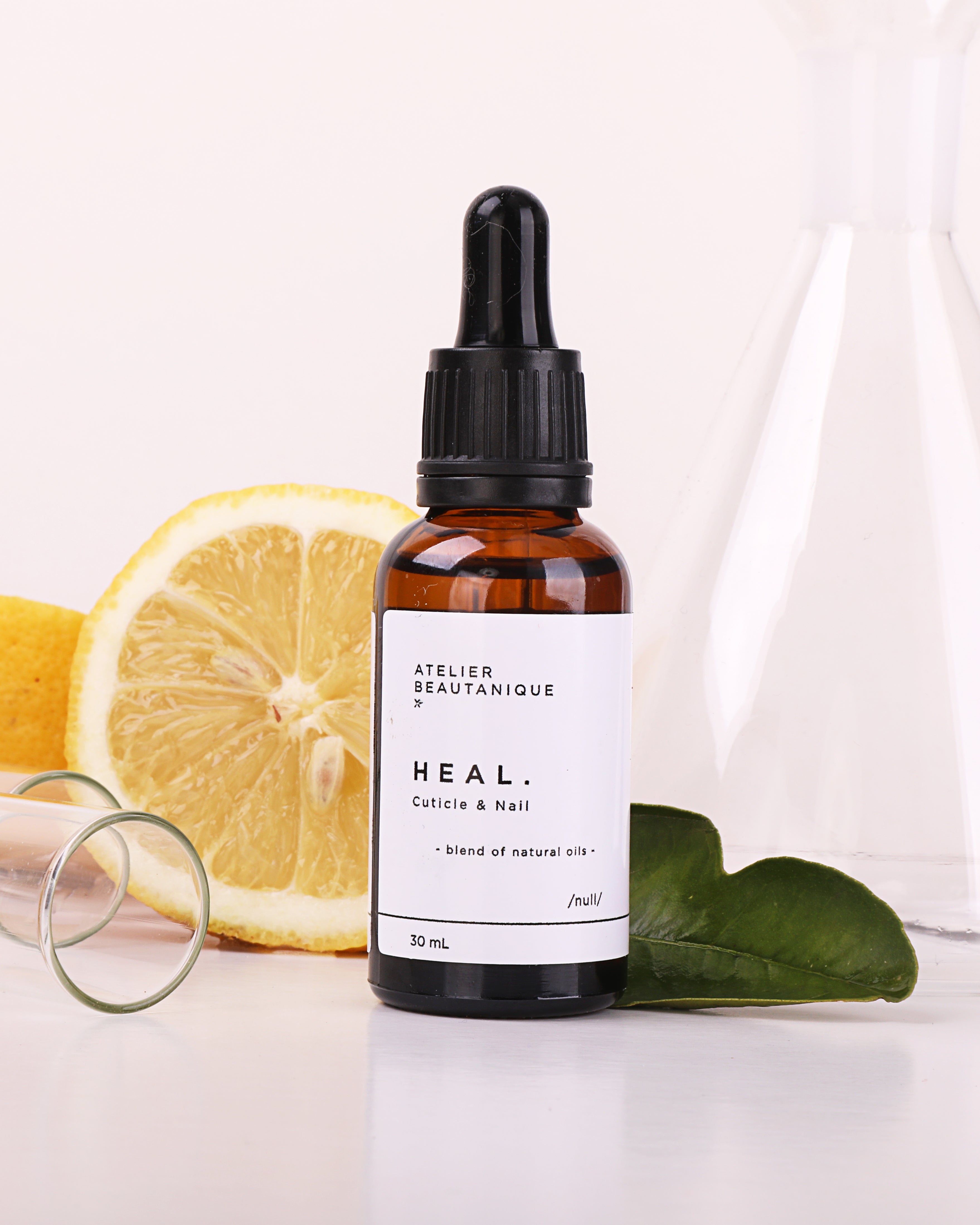 Atelier Beautanique HEAL. Nail & Cuticle Oil Bottle on Grey Background with Light Shadow
